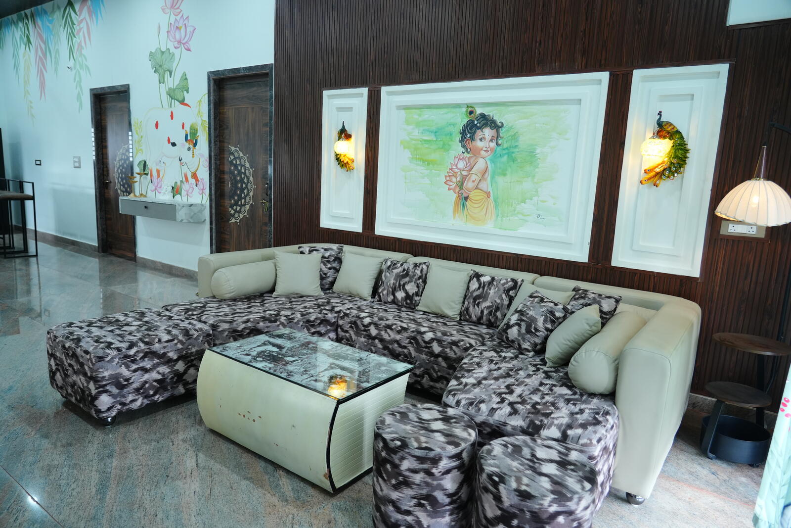 Living room with sectional sofa and hand-painted Krishna artwork